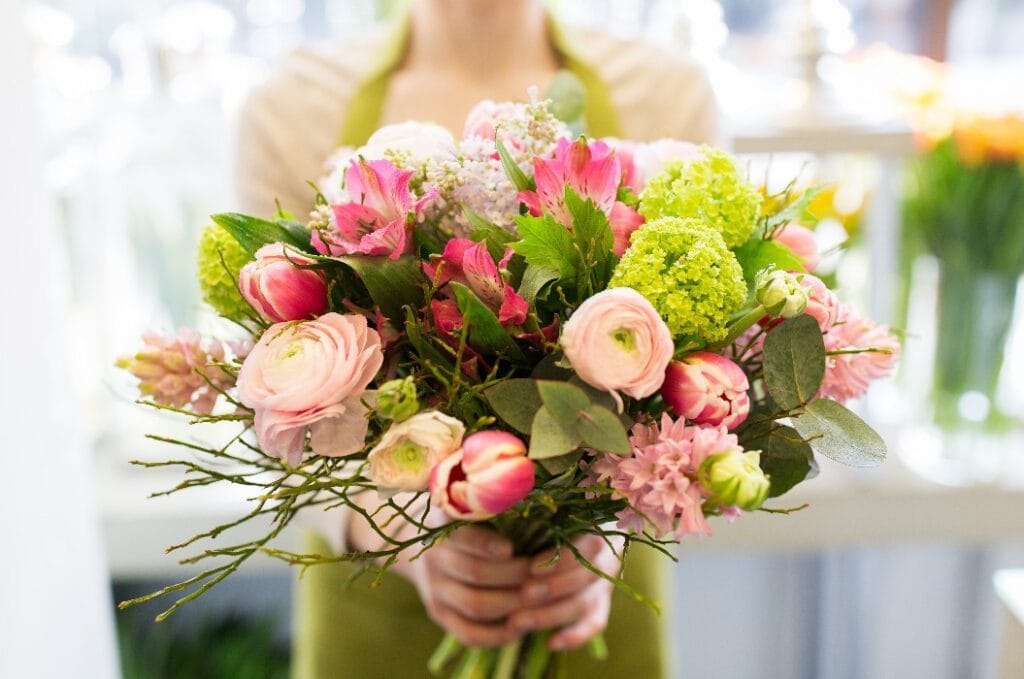 close up of woman holding bunch at flower shop